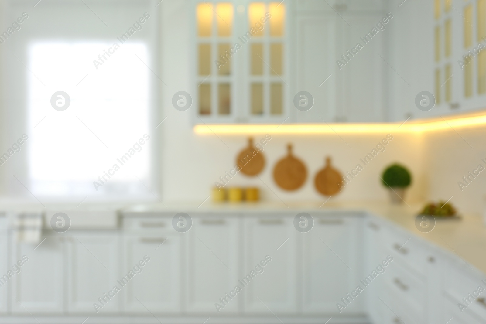 Photo of Blurred view of modern kitchen interior with stylish furniture