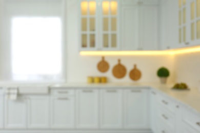 Photo of Blurred view of modern kitchen interior with stylish furniture