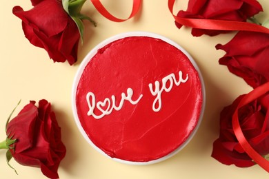 Bento cake with text Love You and red roses on beige table, top view. St. Valentine's day surprise