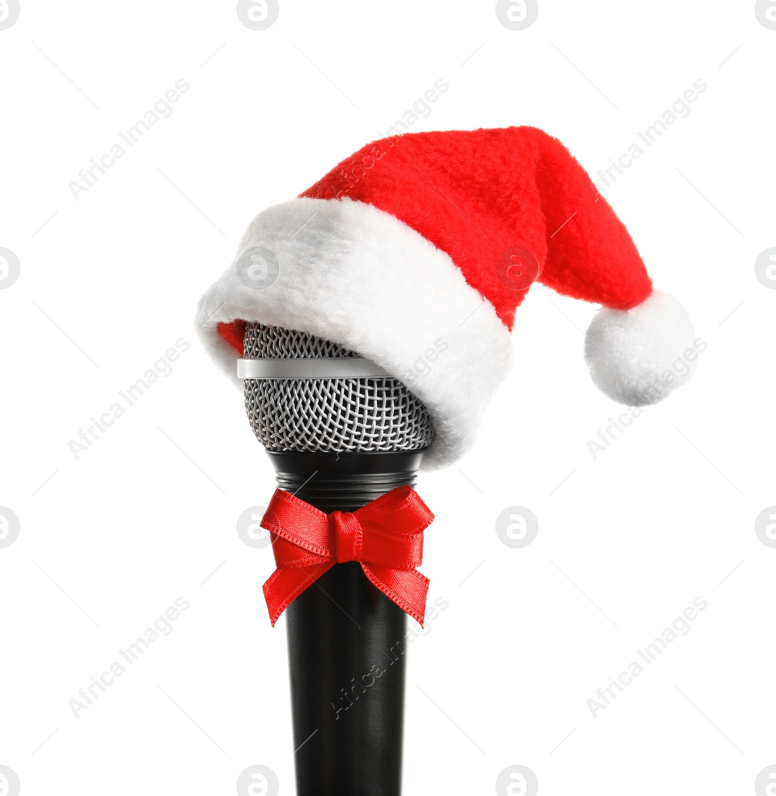 Photo of Microphone with Santa hat and bow on white background. Christmas music concept