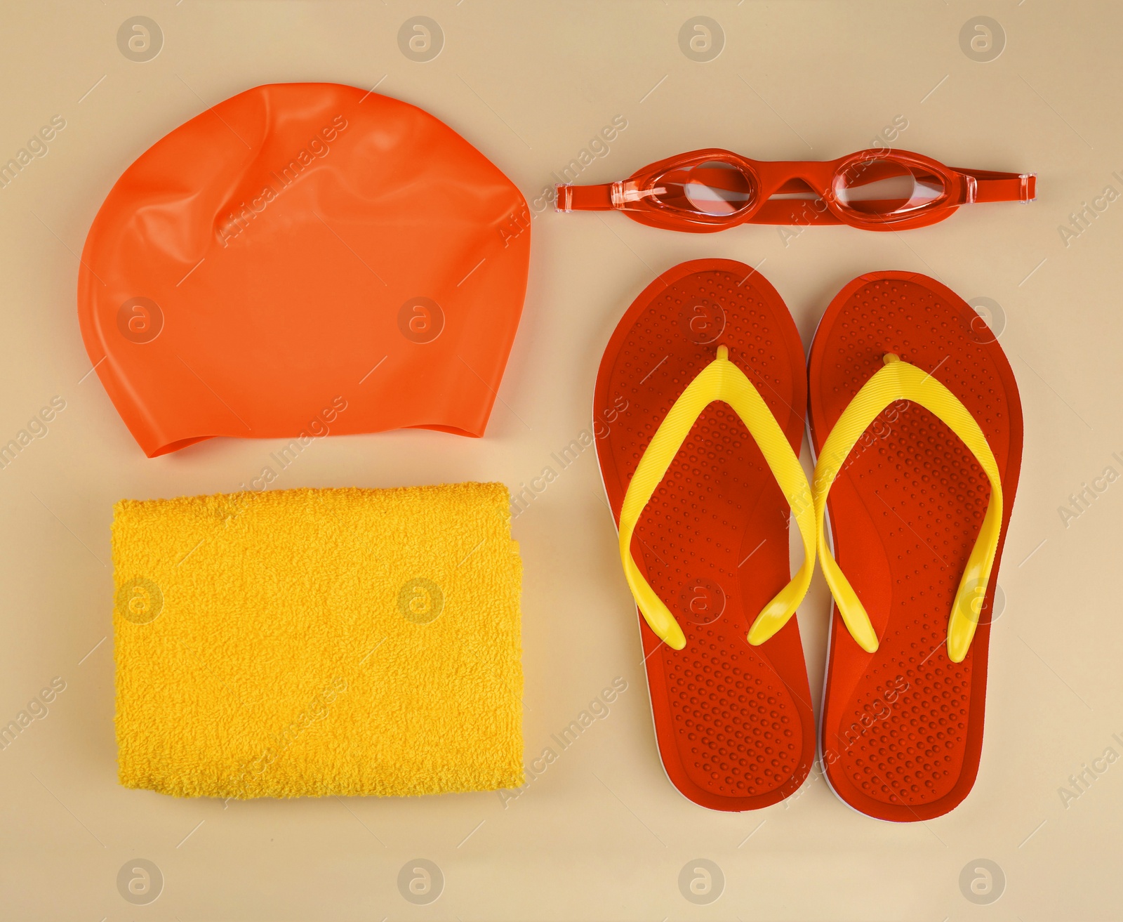 Image of Flat lay composition with orange swimming accessories on beige background