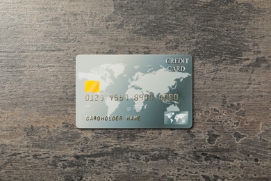 Credit card on grey table, top view