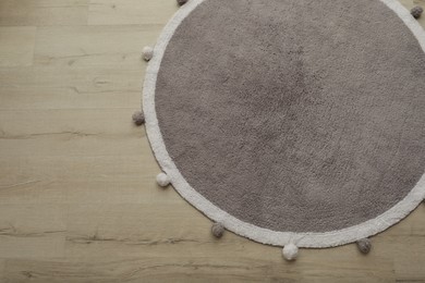 Stylish soft rug on floor, above view. Space for text