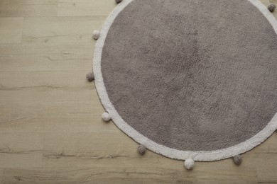 Photo of Stylish soft rug on floor, above view. Space for text