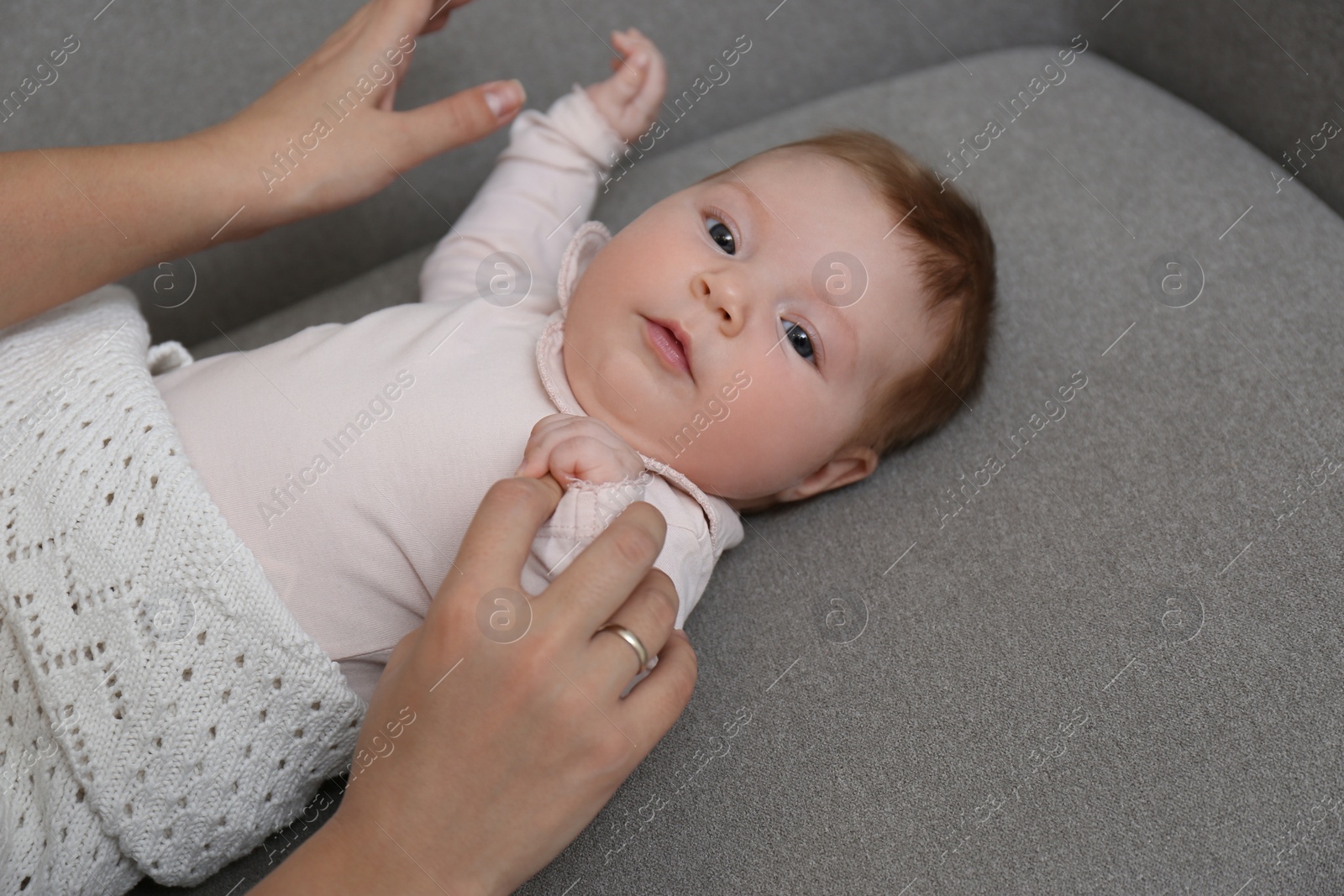 Photo of Young woman with her little baby resting after breast feeding at home, closeup