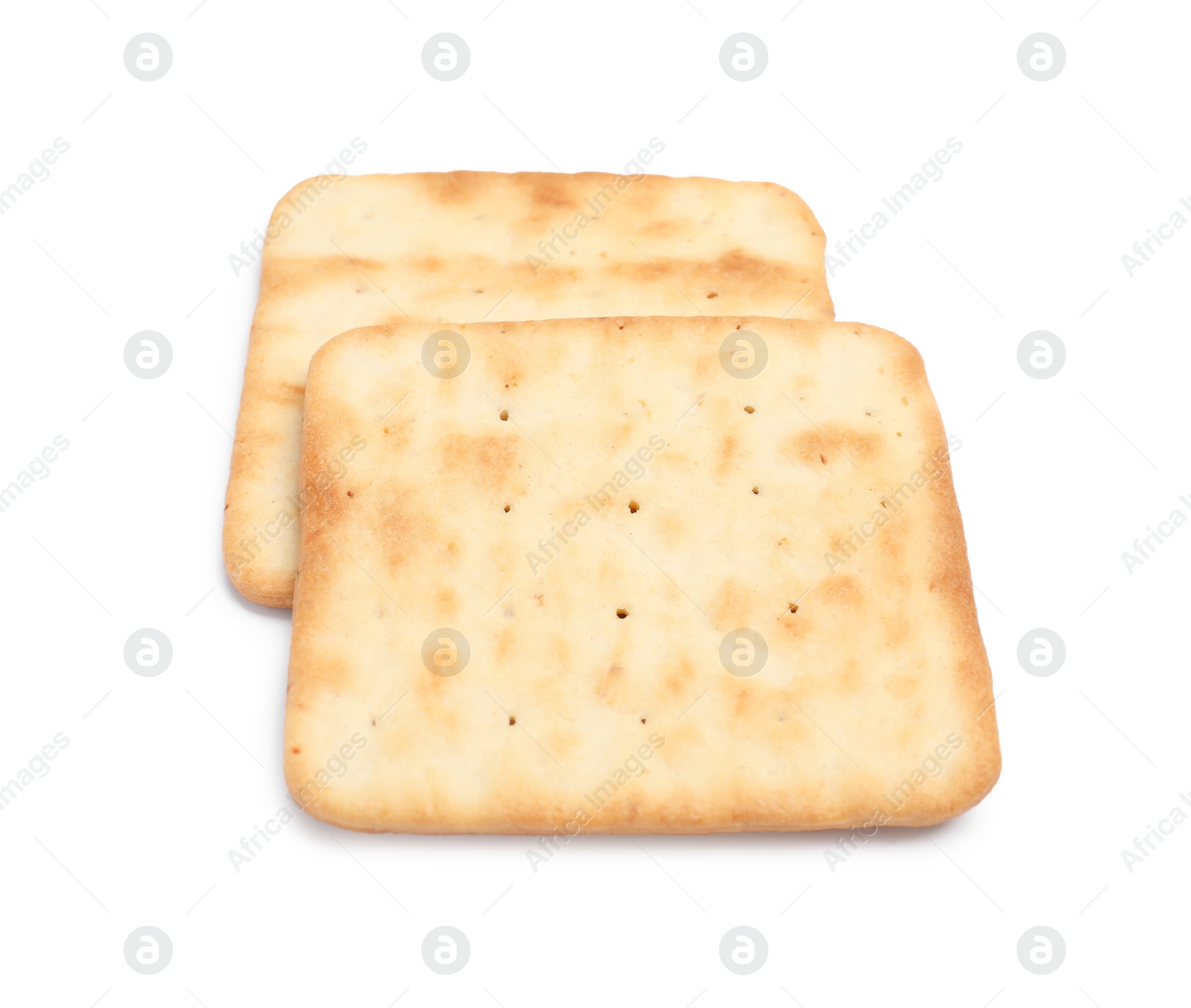 Photo of Tasty crispy square crackers isolated on white