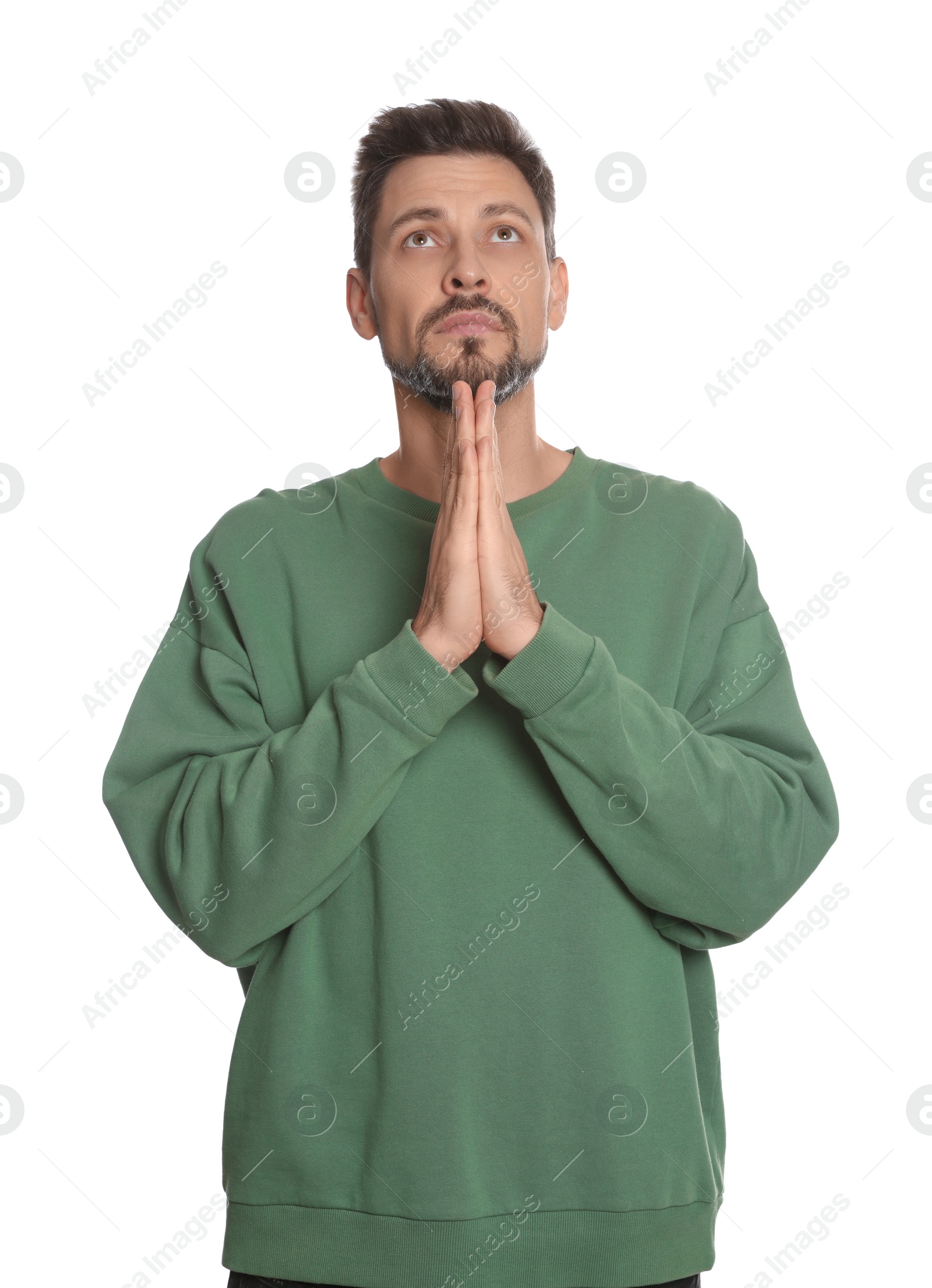 Photo of Man with clasped hands praying on white background