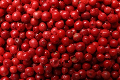 Photo of Aromatic spice. Red pepper as background, top view