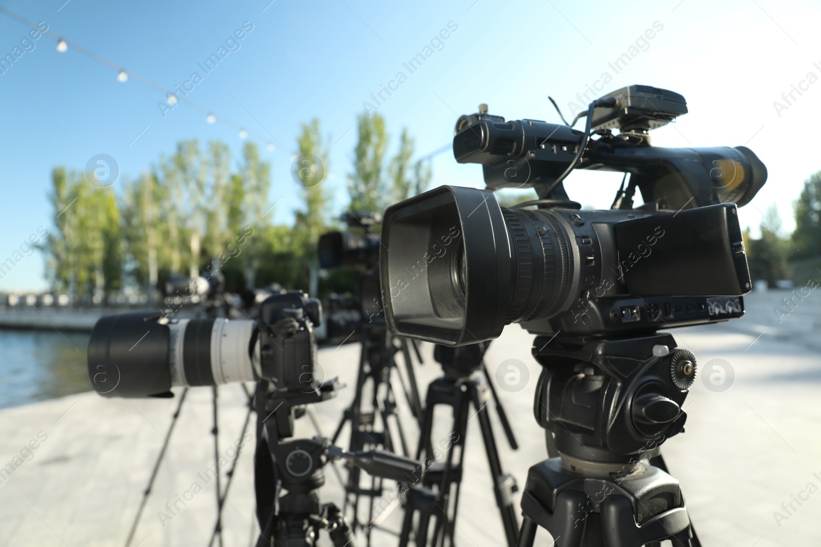 Photo of Modern professional video cameras outdoors on sunny day
