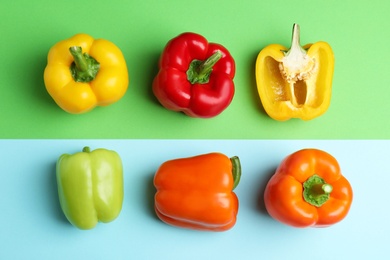 Flat lay composition with ripe bell peppers on color background