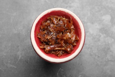 Photo of Modern hookah bowl with tobacco on grey table, top view