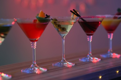 Different martini cocktails on table in bar, closeup