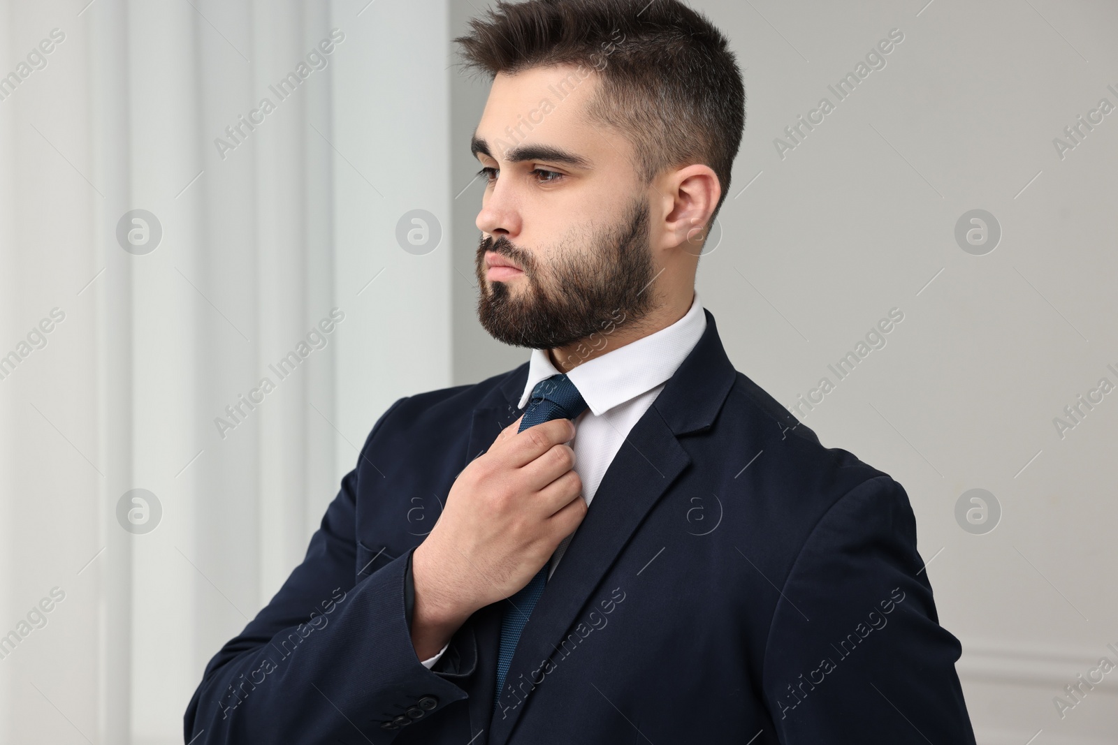 Photo of Handsome businessman in suit and necktie indoors