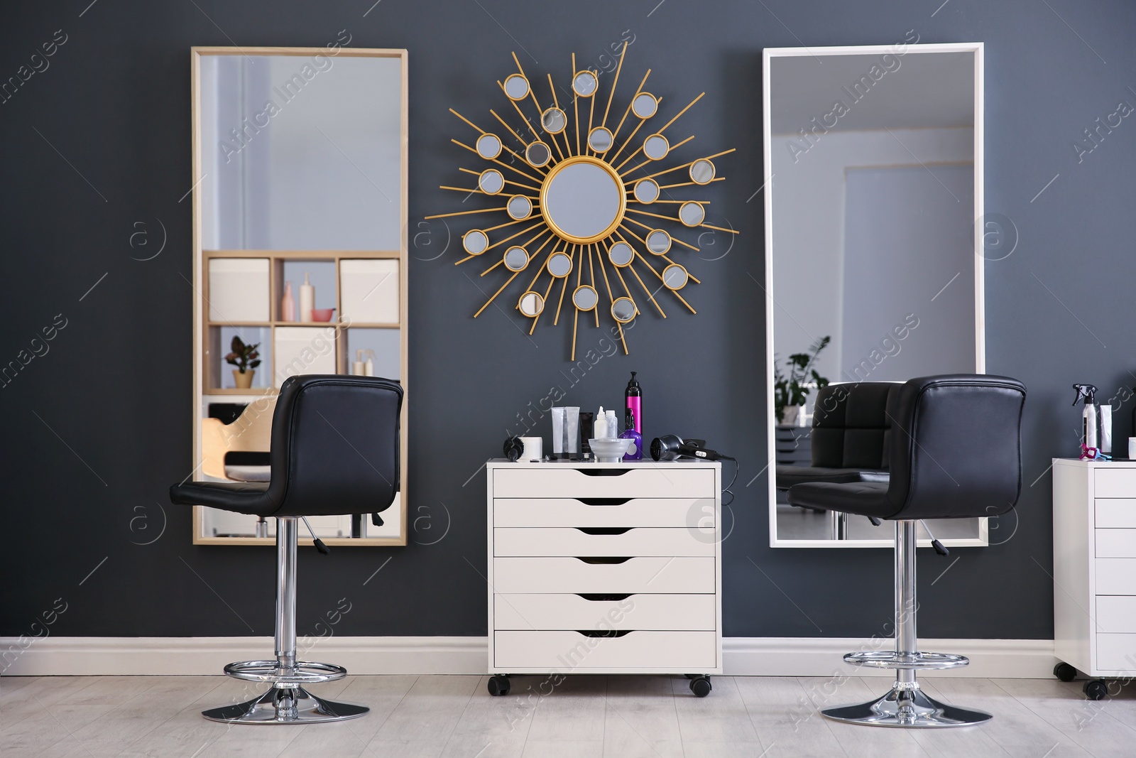 Photo of Stylish interior with hairdresser's workplace in beauty salon