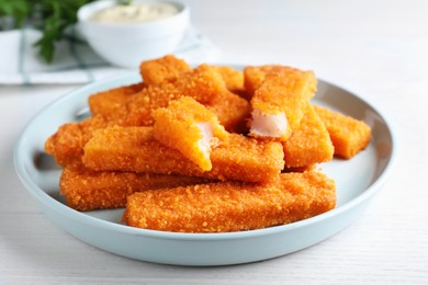 Photo of Fresh breaded fish fingers served on white table
