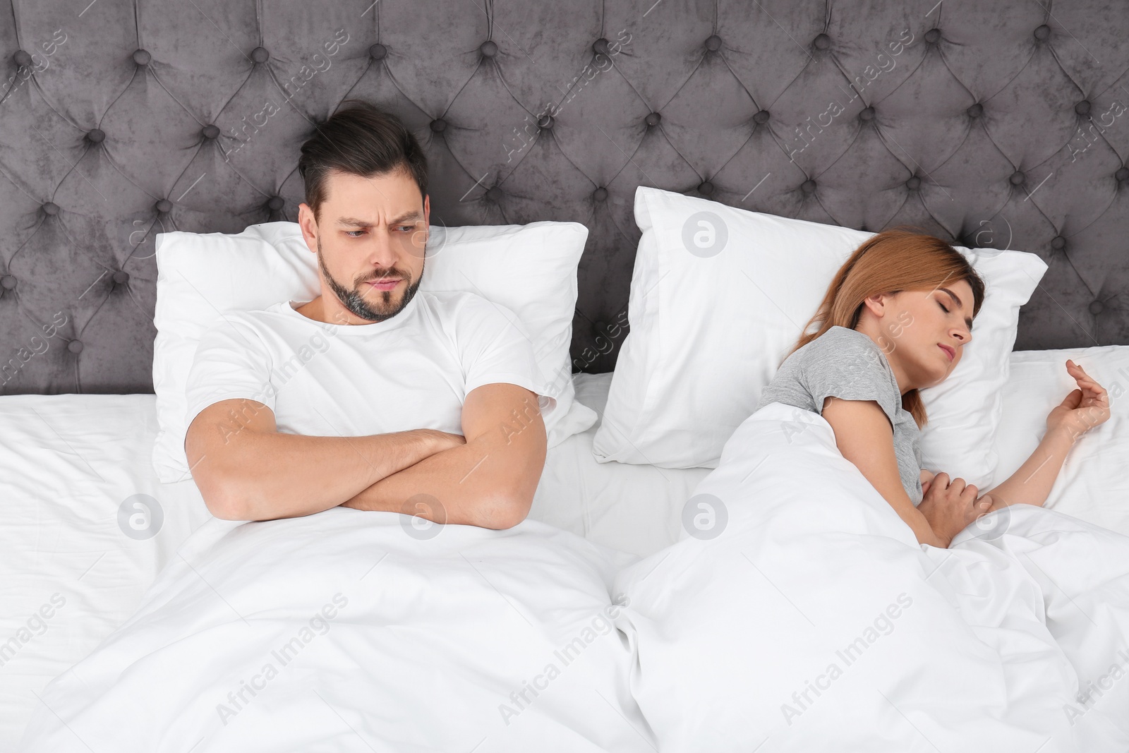 Photo of Couple with relationship problems in bed at home