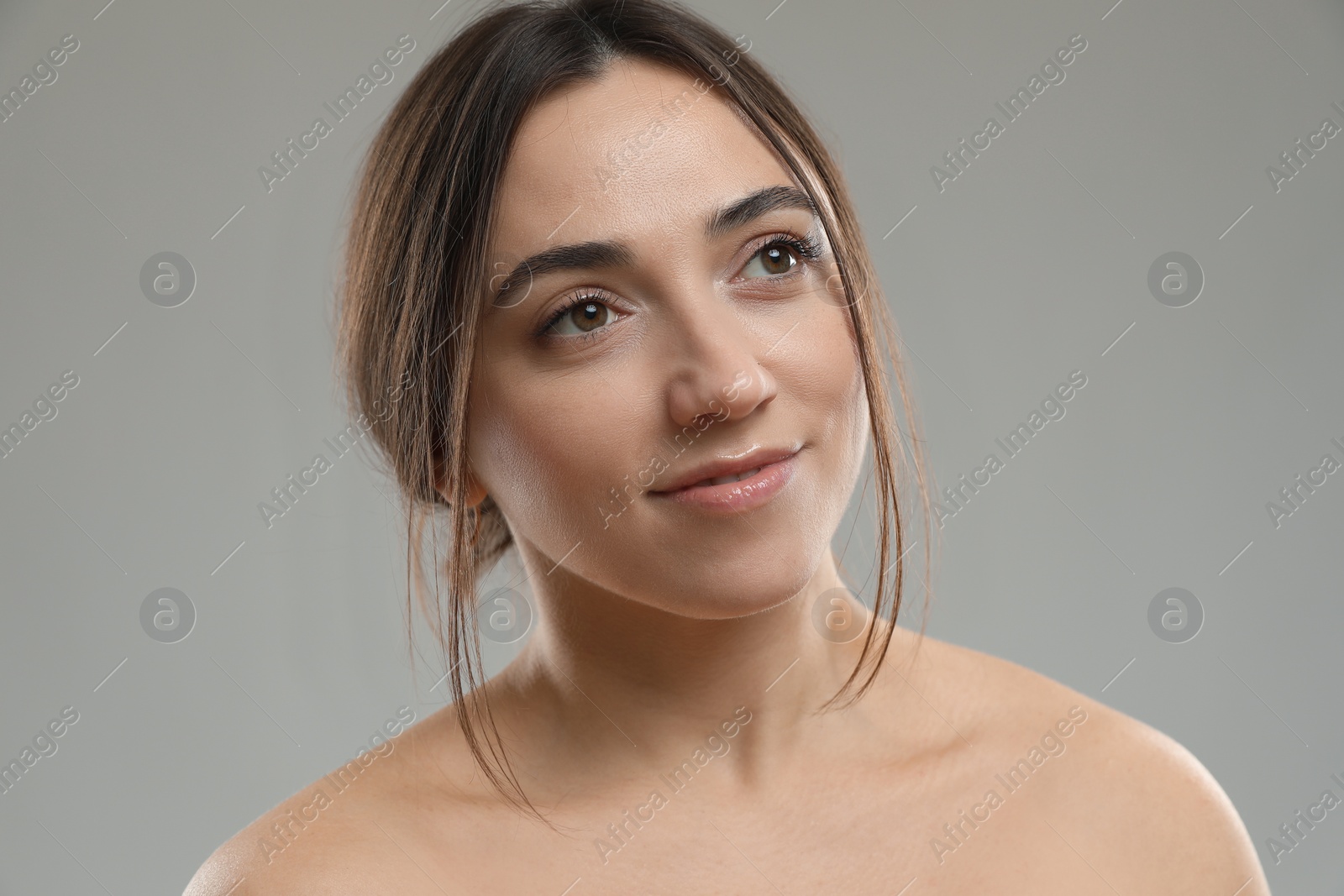 Photo of Portrait of beautiful woman on grey background