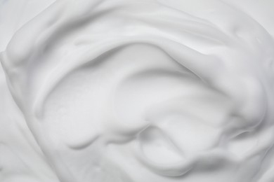Texture of white shaving foam as background, top view