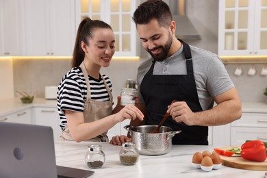 Photo of Lovely young couple cooking together in kitchen