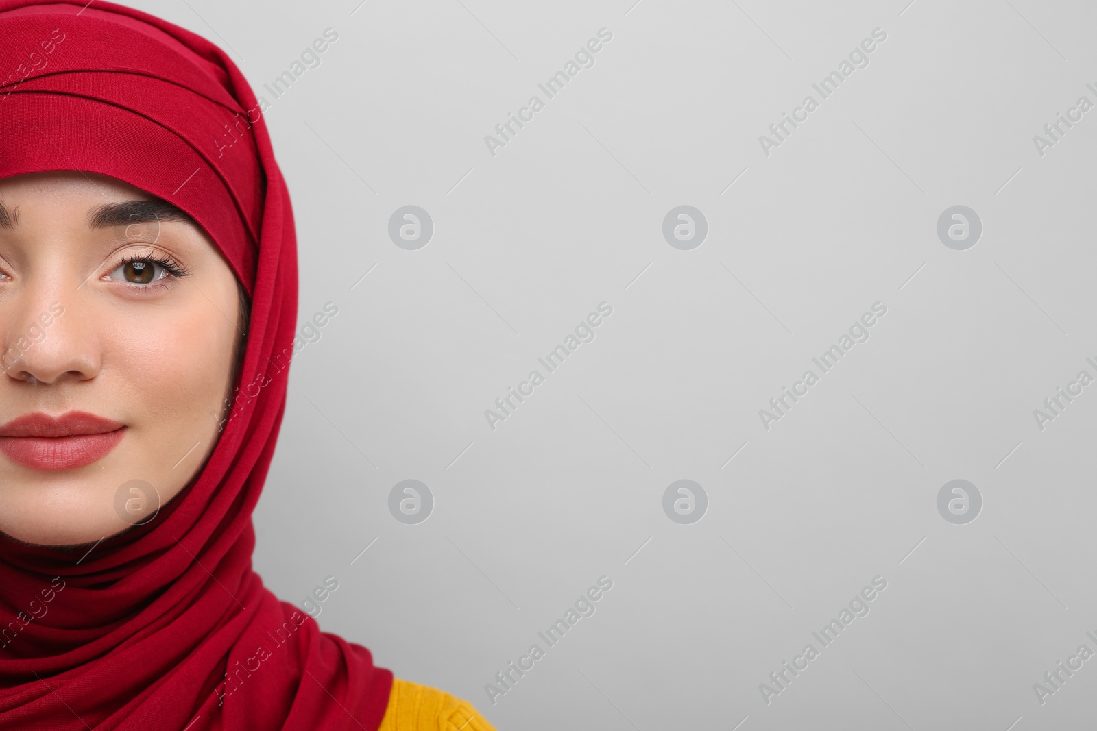 Photo of Muslim woman in hijab on light gray background, space for text
