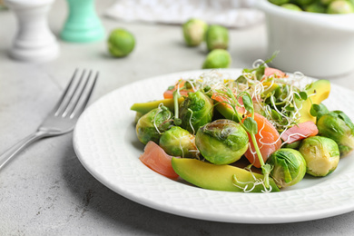 Photo of Tasty salad with Brussels sprouts on grey table, closeup