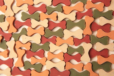 Flat lay composition with many bone shaped vitamins for pets on beige background