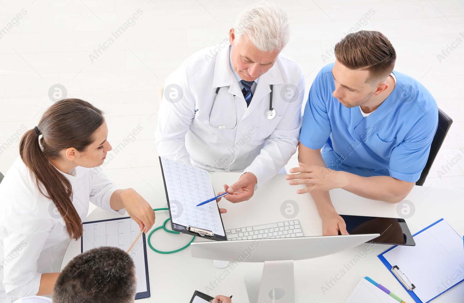 Photo of Group of doctors attending meeting in clinic. Cardiology conference