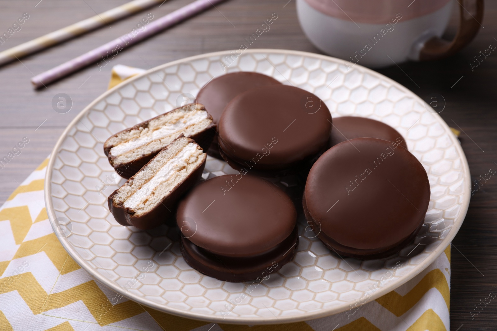 Photo of Tasty choco pies on wooden table. Snack cakes