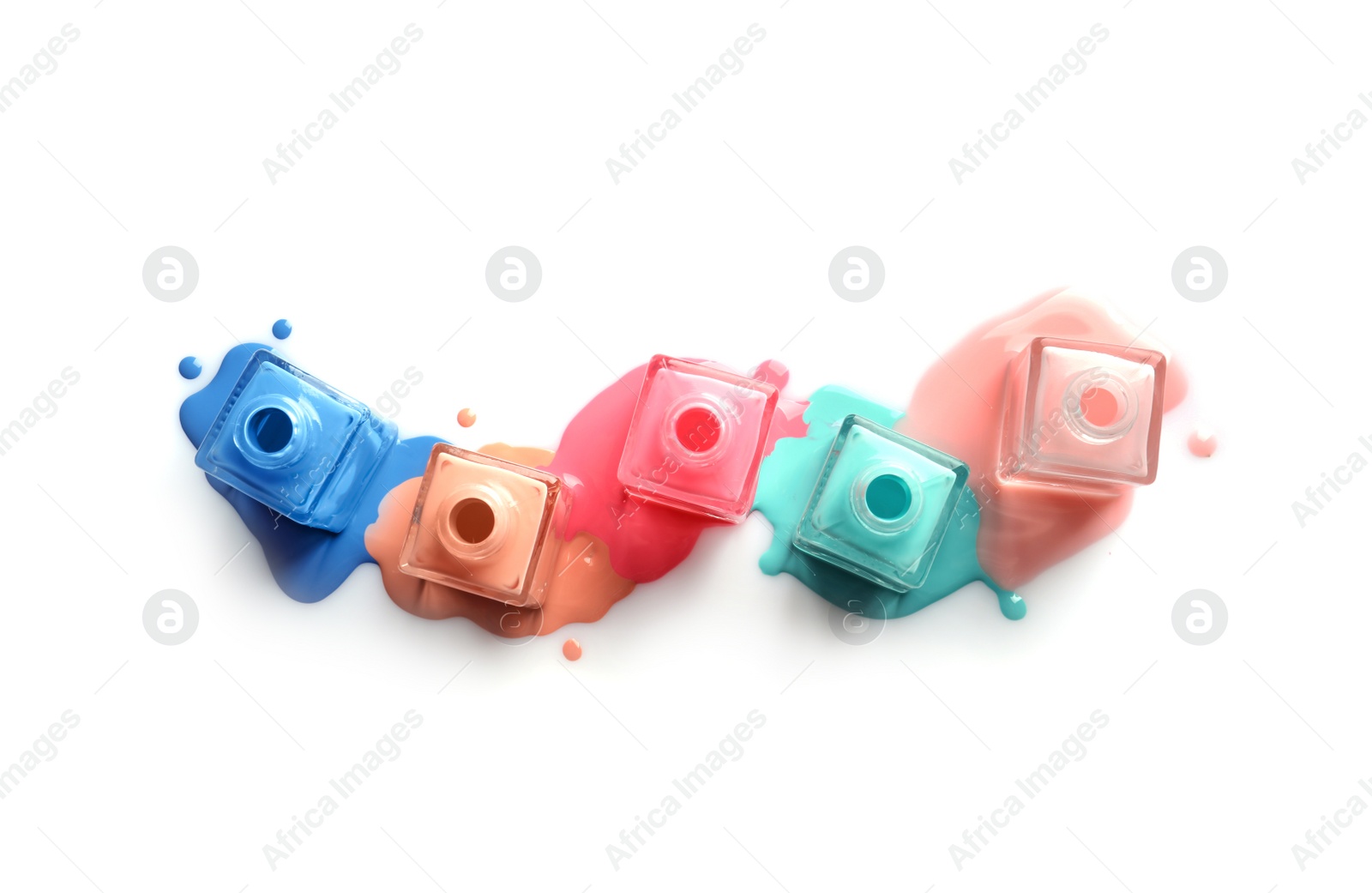 Photo of Spilled different nail polishes with bottles on white background, top view