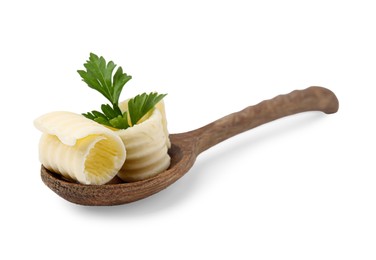 Tasty butter curls and fresh parsley in spoon isolated on white