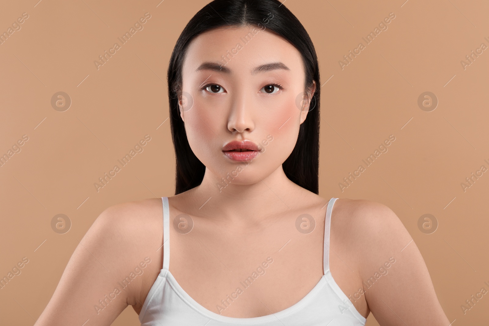 Photo of Beautiful woman with healthy skin on beige background