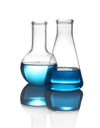 Laboratory glassware with liquid on table against white background. Chemical analysis