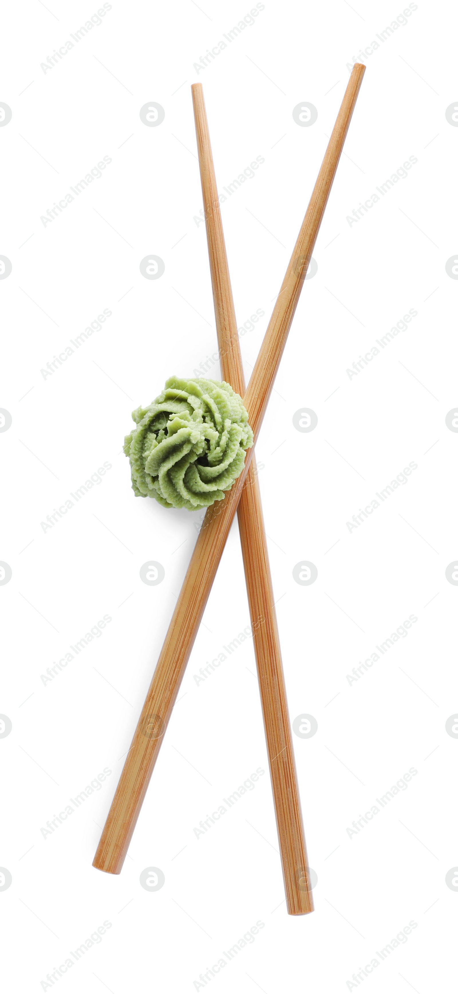 Photo of Swirl of wasabi paste and chopsticks on white background, top view