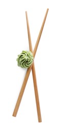 Photo of Swirl of wasabi paste and chopsticks on white background, top view