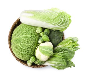 Photo of Wicker bowl with different types of fresh cabbage on white background, top view