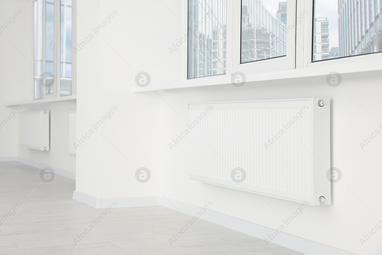 Photo of Modern office room with radiators and windows. Interior design