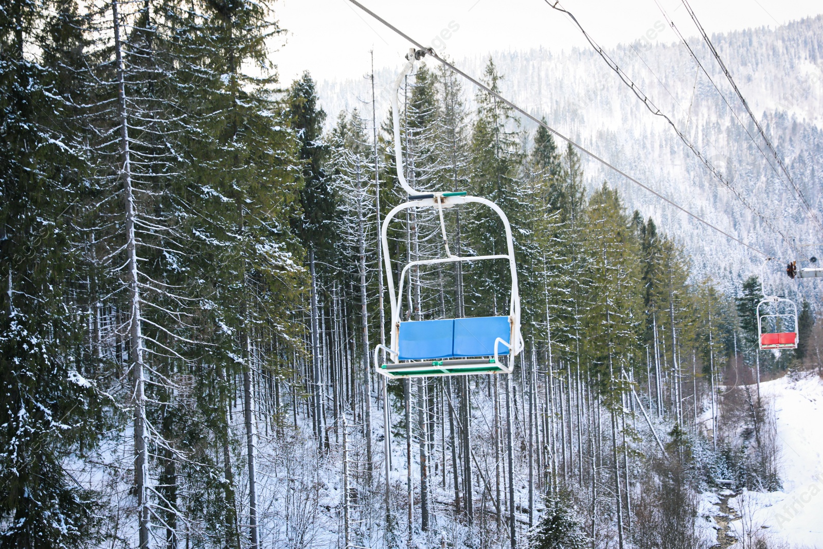 Photo of Empty chairlift at mountain ski resort. Winter vacation