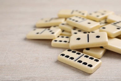 Domino tiles on wooden table. Space for text