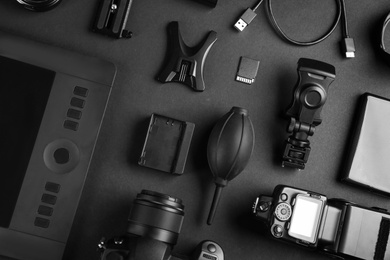 Photo of Flat lay composition with video production equipment for camera on black background