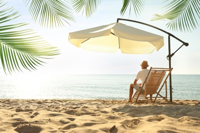 Image of Man enjoying his summer vacation on sandy beach