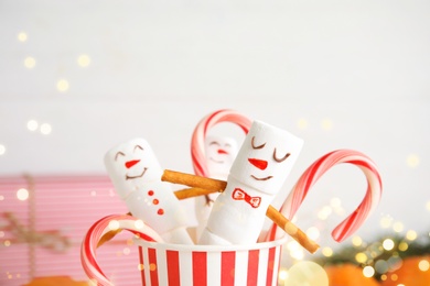 Image of Funny snowmen made of marshmallows in paper cup, closeup. Bokeh effect 