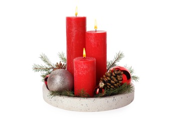 Beautiful burning candles with Christmas decor on white background