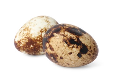 Beautiful speckled quail eggs on white background