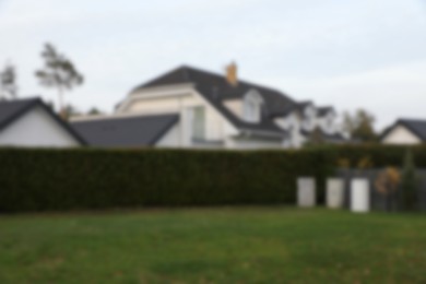 Blurred view of beautiful houses outdoors. Real estate