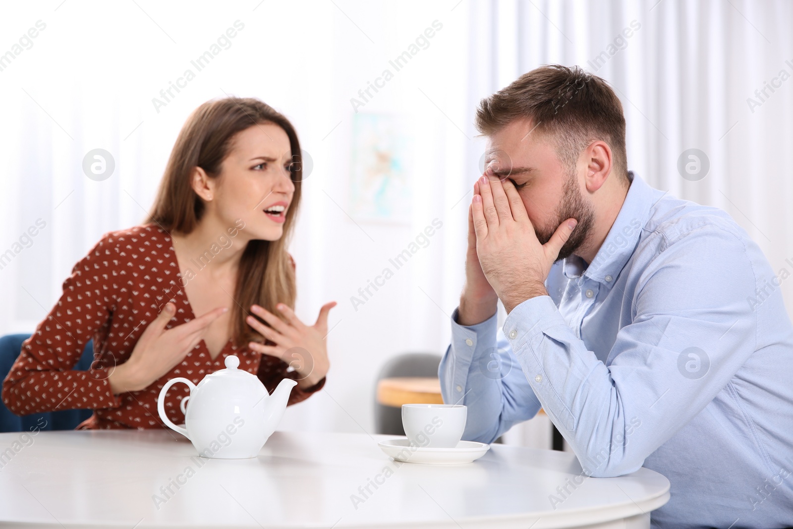 Photo of Couple having quarrel in cafe. Relationship problems