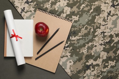 Photo of Stationery, apple and diploma on color background, flat lay with space for text. Military education