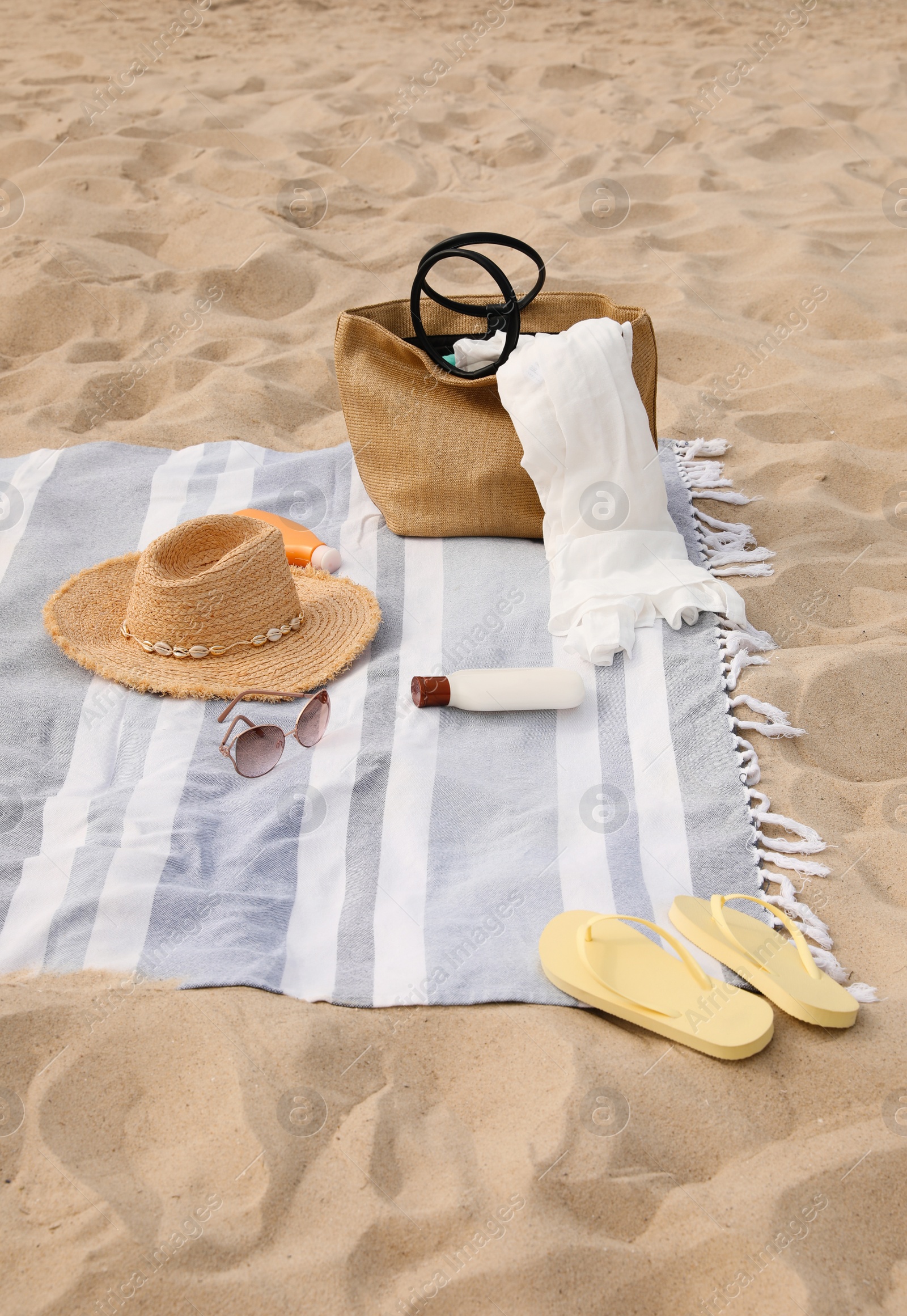 Photo of Bag and other beach items on sand