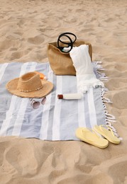 Photo of Bag and other beach items on sand