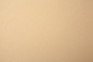 Sheet of beige paper as background, top view