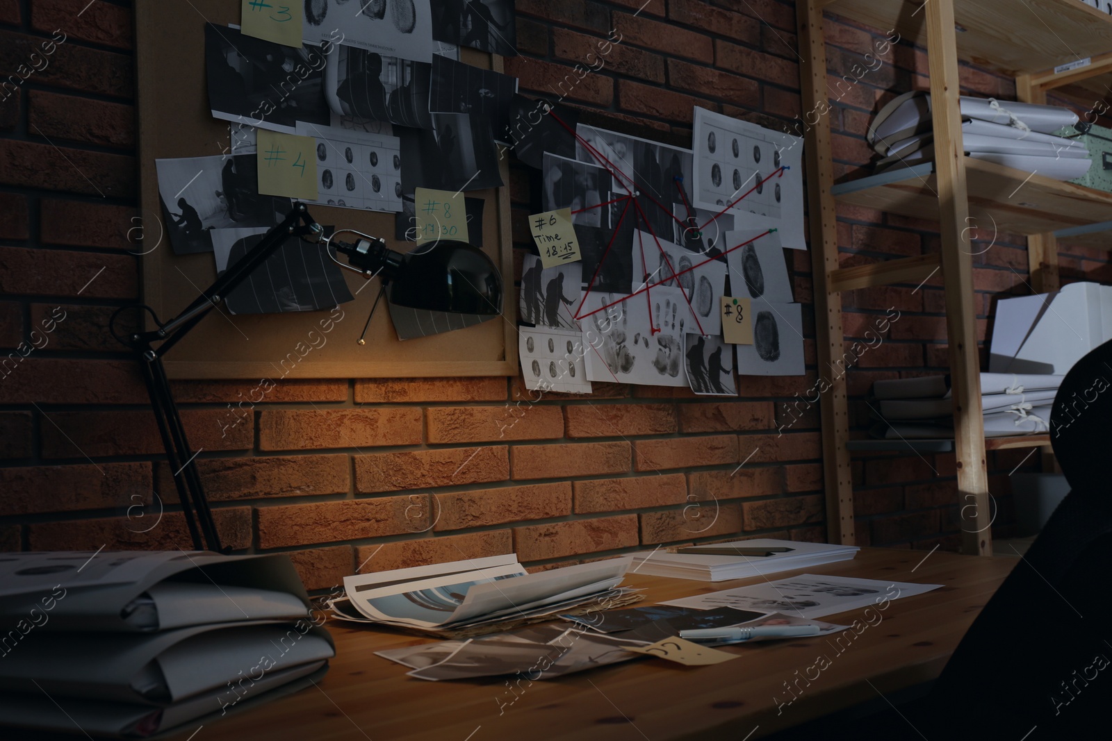 Photo of Detective workplace near brick wall in office